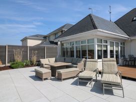 A garden area with seating and loungers at Sunnyside, River Chapel near Courtown, County Wexford