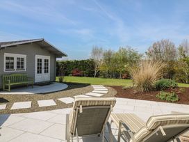 A garden with a shed and seating area at Sunnyside River Chapel near Courtown, County Wexford