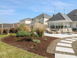 A garden with patio and deck chairs at Sunnyside River Chapel near Courtown, County Wexford