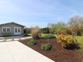 A garden with a shed and a bench at Sunnyside, River Chapel near Courtown, County Wexford