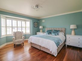 A bedroom with a bed and nightstands at Sunnyside, River Chapel near Courtown, County Wexford