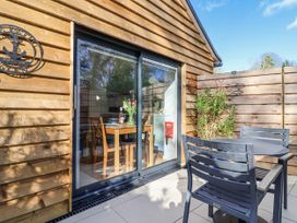 An outdoor area with a table and chairs at Le Petit Glen in Uplyme