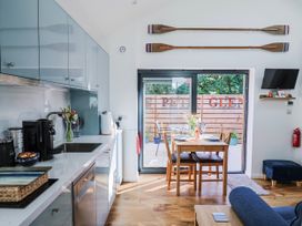 A kitchen with dining area and coffee maker at Le Petit Glen in Uplyme
