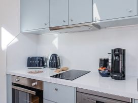 A kitchen with appliances and countertops at Le Petit Glen in Uplyme