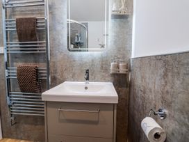 A bathroom with a sink and towel rack at Le Petit Glen in Uplyme
