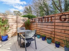 An outdoor area with a table and chairs at Le Petit Glen in Uplyme