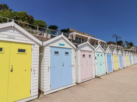 A row of beach huts with colorful doors at Le Petit Glen in Uplyme