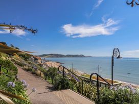 A beach view with a pathway and stairs at Le Petit Glen in Uplyme