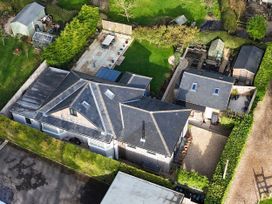 An aerial view of a property with gardens and structures at Le Petit Glen in Uplyme