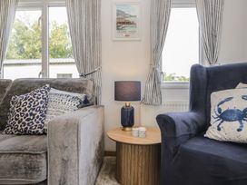 A living room with a sofa and side table at Hedgerow Lodge near Haven Lakeside Grange-Over-Sands