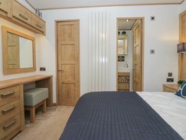 A bedroom with a desk and mirror at Hedgerow Lodge near Haven Lakeside Grange-Over-Sands