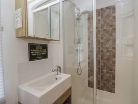 A bathroom with a shower and sink at Hedgerow Lodge Haven Lakeside near Grange-Over-Sands