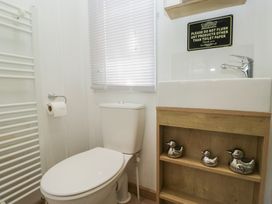 A bathroom with a toilet and sink at Hedgerow Lodge near Haven Lakeside in Grange-Over-Sands