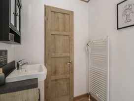 A bathroom with a sink and towel rail at Hedgerow Lodge Haven Lakeside near Grange-Over-Sands