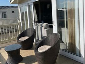 An outdoor seating area with chairs and a table at Tattershall Lakes Country Park - Holiday Accommodation 20875, Lincoln