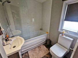 A bathroom with a bathtub, shower, sink, and toilet at Tattershall Lakes Country Park - Holiday Accommodation 20875 Lincoln