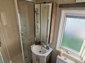 A bathroom with a shower and wash basin at Tattershall Lakes Country Park - Holiday Accommodation 20875 Lincoln