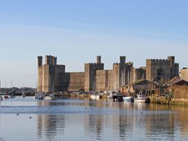 A castle and boats on water at Trwyn Cam Brynrefail near Llanberis