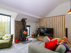 A living room with a fireplace and television at Trwyn Cam near Brynrefail Llanberis