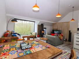 A living room with a sofa and a coffee table at Trwyn Cam in Brynrefail near Llanberis