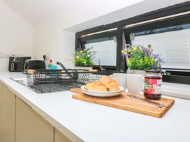 A kitchen with croissants and jam on the counter at Trwyn Cam Brynrefail near Llanberis
