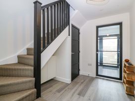 A hallway with a staircase and doors at Trwyn Cam Brynrefail near Llanberis