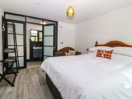 A bedroom with a bed and wardrobe at Trwyn Cam Brynrefail near Llanberis