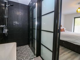 A bathroom with a shower and bathtub at Trwyn Cam in Brynrefail near Llanberis