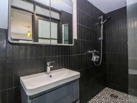 A bathroom with a sink and shower at Trwyn Cam in Brynrefail near Llanberis