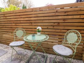 An outdoor seating area with a table and two chairs at Trwyn Cam Brynrefail near Llanberis