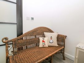 A seating area with a bench and cushions at Trwyn Cam in Brynrefail near Llanberis