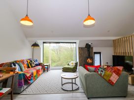 A living room with a sofa and coffee table at Trwyn Cam in Brynrefail near Llanberis