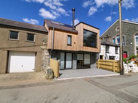 A modern house with wooden features and a garage at Trwyn Cam Brynrefail near Llanberis
