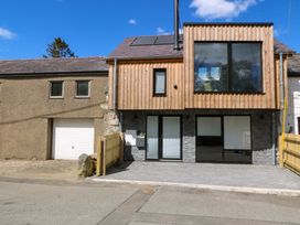 A house with a garage and wooden fence at Trwyn Cam Brynrefail near Llanberis