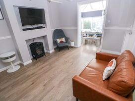 A living room with a television and sofa at The Wool Pack in Tenby