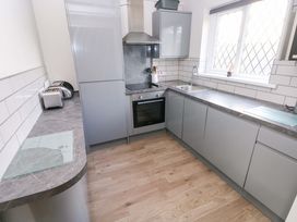A kitchen with a sink and oven at The Wool Pack in Tenby