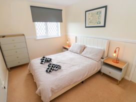 A bedroom with a bed and drawers at The Wool Pack in Tenby
