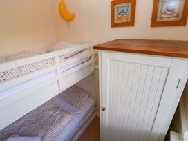 A bedroom with a bunk bed and a wardrobe at The Wool Pack in Tenby