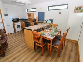 A kitchen with dining area and appliances at Brookview Kingfisher in Haverfordwest