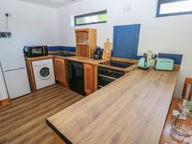 A kitchen with appliances and wooden countertops at Brookview Kingfisher Haverfordwest