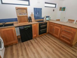 A kitchen with cabinets, sink, dishwasher, and cooking hob at Brookview Kingfisher in Haverfordwest