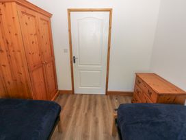 A bedroom with a wardrobe and a drawer at Brookview Kingfisher Haverfordwest