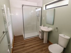 A bathroom with a shower, sink and toilet at Brookview Kingfisher Haverfordwest
