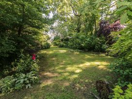 A garden with grass and trees at Brookview Kingfisher in Haverfordwest