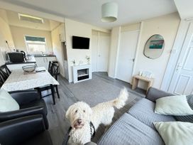 A living room with a table and chairs at Chalet 62, California, Norfolk