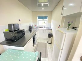A kitchen with a sink and appliances at Chalet 62 in California, Norfolk