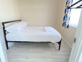 A bedroom with a bed and window at Chalet 62 California, Norfolk
