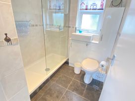 A bathroom with shower, toilet, and sink at Chalet 62 in California, Norfolk
