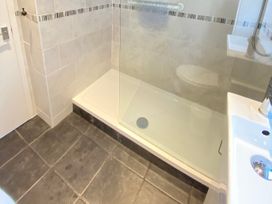 A bathroom with a shower, toilet, and sink at Chalet 62 in California, Norfolk
