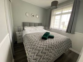 A bedroom with a bed and nightstand at Chalet 57 in California, Norfolk